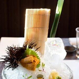 Order the Uni, nesting on a green leaf supported by strands of white daikon and chipped ice, the bright orange slabs of uni create a tableau complete with quail egg, petals and a large block of ice.