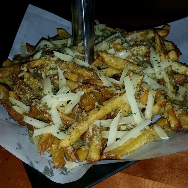 Photo taken at Canuck&#39;s Poutinerie by Heloisa Y. on 1/6/2015
