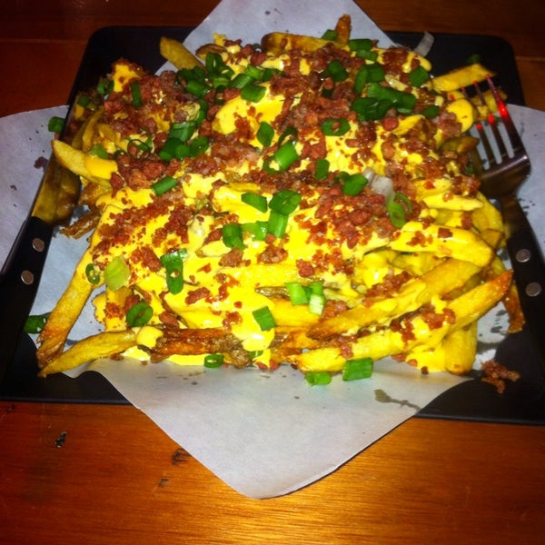 Photo taken at Canuck&#39;s Poutinerie by Junior O. on 3/15/2014