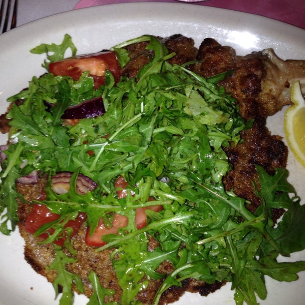 Delicious veal chop pounded for Milanese with arugula and tomato. Perfect.
