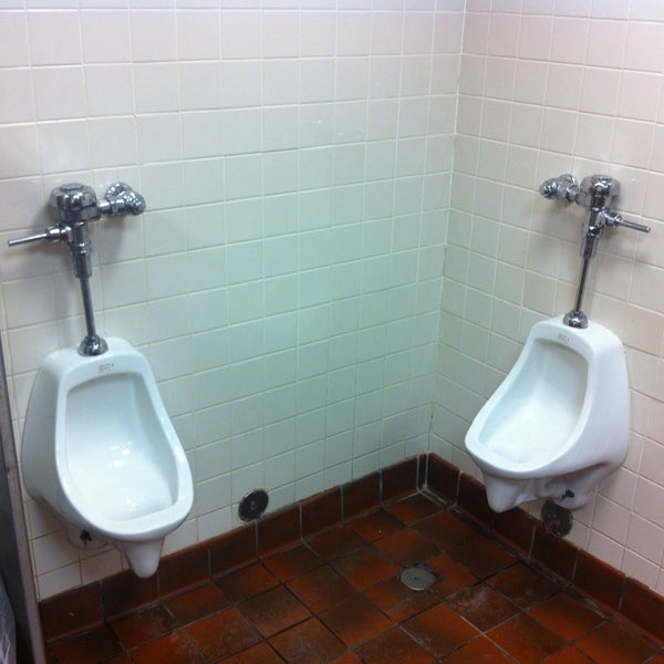 The men's restroom has 2 urinals in the corner. If two men go at the same time, one guy's butt will be touching the other guy trying to pee.