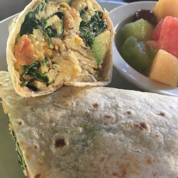The meatless breakfast burrito could use a bit more avocado and less spinach, but it's pretty good covered in some hot sauce. Served with a side of fruit, mostly melons.