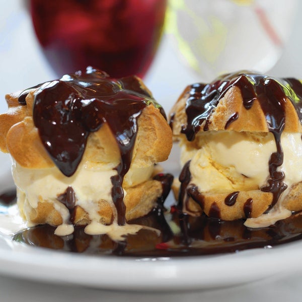 Eat this: profiteroles del Pirineo. Named after the Pyrenees mountains, the dish features two scoops of vanila ice cream sandwiched between puff pastry and topped with bittersweet chocolate sauce.
