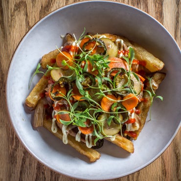Try the Banh mi poutine: fries, slow-roasted pork shoulder, crunchy pickled carrots and fried jalapeños, smothered in a pork-hoisin gravy and drizzled with zippy sriracha and house-made Kewpie mayo.
