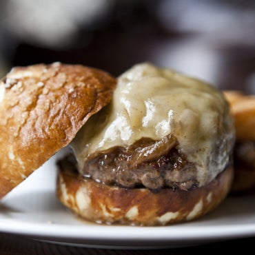 A yeasty pretzel bun—made in-house—holds up to the rich meat of the Griddled TM Burger, while sherried onions and Emmentaler cheese lend a vinegary zip and nuttiness.