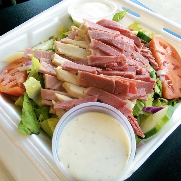 JOHN WAYNE SALAD - Fresh cut romaine lettuce, cucumber, tomatoes & red onion with chopped Dearborn Ham, Sy Ginsberg Corned Beef, turkey breast & Swiss cheese w/ house-made ranch dressing.
