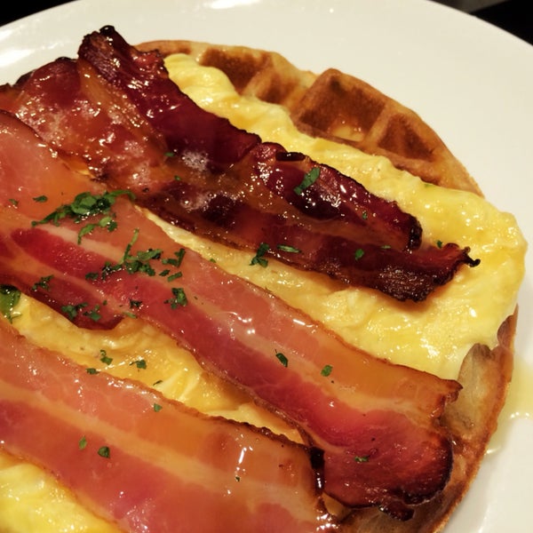 Crispy bacon on soft eggs and waffles, drenched in syrup. Salty and sweet together is yummy!