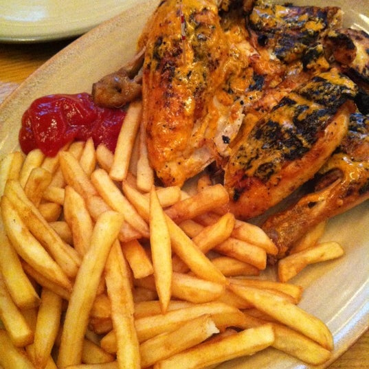 Photo taken at Nando&#39;s by Sunga S. on 5/21/2012