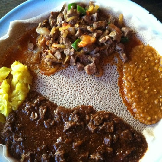 Photo taken at Queen Sheba Ethiopian Restaurant by Chelle T. on 4/22/2012