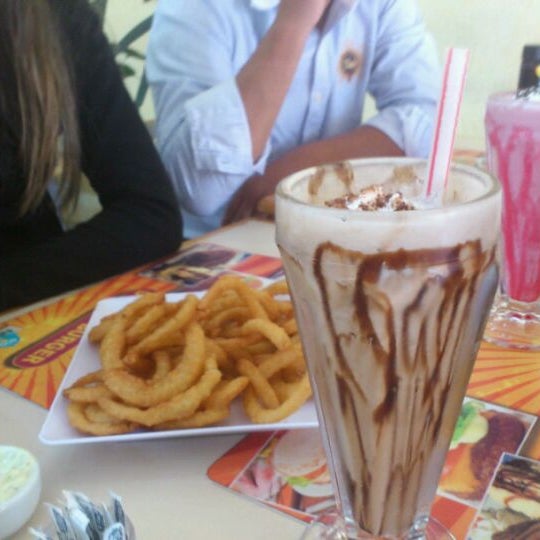 Photo taken at Dukin&#39;s Burger by Miguel S. on 5/4/2012