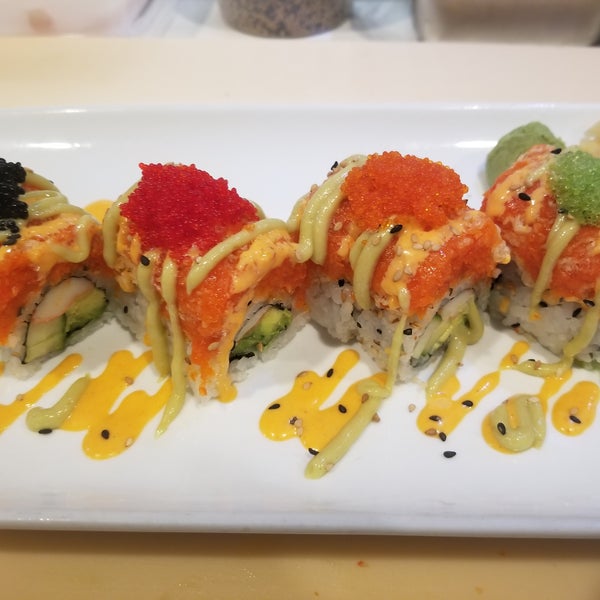 Sexy lady roll. California roll top with spicy salmon and tobikos.
