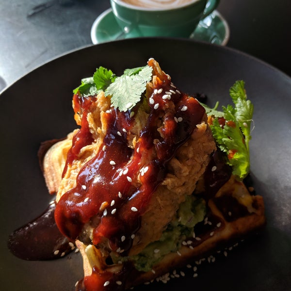 Crispy fried chicken with lashings of guacamole atop a house baked corn and chive waffle drizzled with Korean style sweet and spicy sauce.