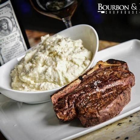 Photo taken at Bourbon &amp; Bones Chophouse and Bar by Yext Y. on 9/15/2017