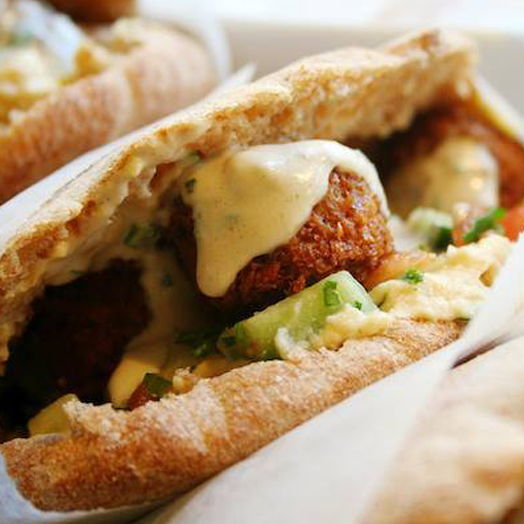 Taïm offers a high-end twist on Tel Aviv street food. The falafel sandwich—green falafel, hummus, tahini and Israeli salad, all nestled inside a thick, warm blanket of pita—is seriously life-changing.