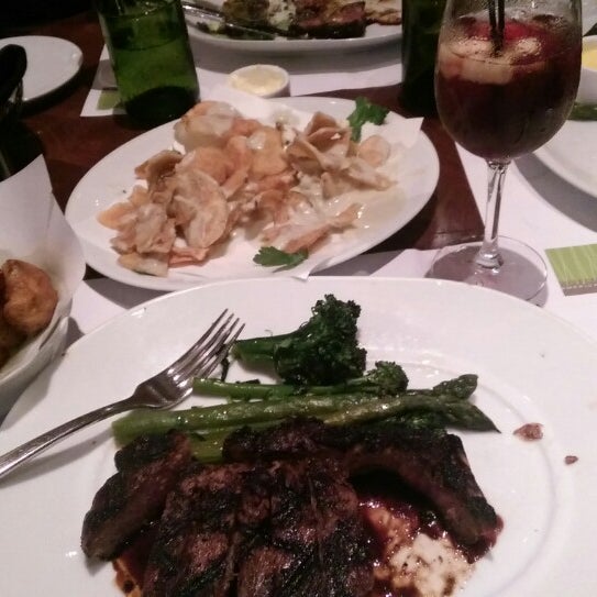Photo taken at Wolfgang Puck American Grille by Ricky C. on 6/14/2014