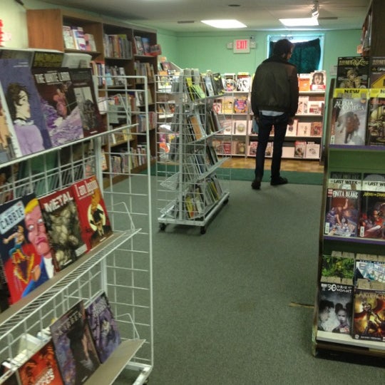 Photo taken at Green Brain Comics by Qdoba Mexican Grill E. on 4/1/2012