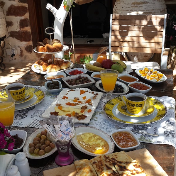 Turkish Breakfast with a rich selection of homemade jams and fresh orange juice under lemon and orange trees at the historical alanya house garden ..