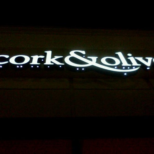 Photo taken at Cork &amp; Olive by Topher A. on 3/9/2011