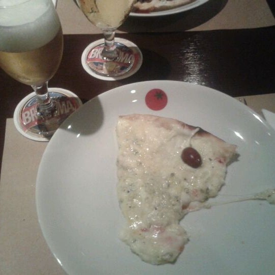 Photo taken at Soggiorno Pizza Bar by Camila A. on 3/11/2012
