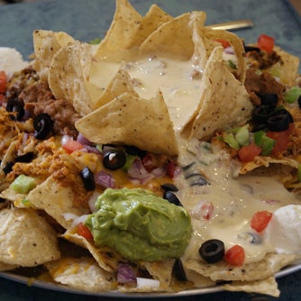 On Man v Food, Adam faces the Mount Nacheesmo Challenge: 5 lbs of nachos loaded with beef, chicken, beans, cheddar, jack cheese, tomatoes, green peppers, olives, lettuce, onions, sour cream & guac.