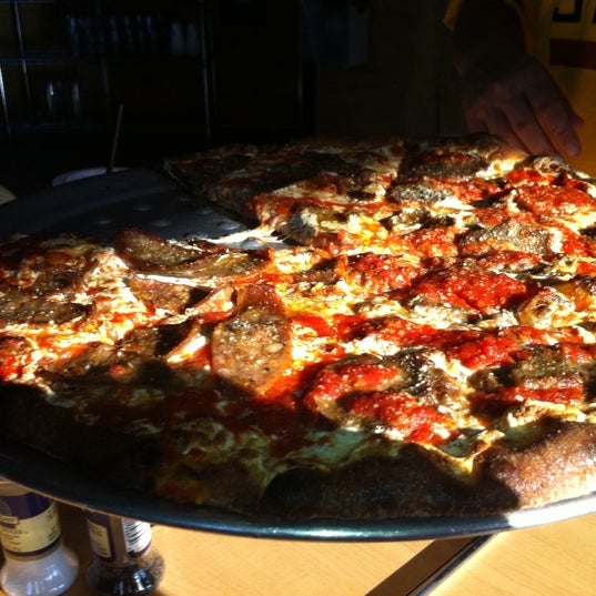 Photo taken at Tucci&#39;s Fire N Coal Pizza by Christopher H. on 4/9/2011