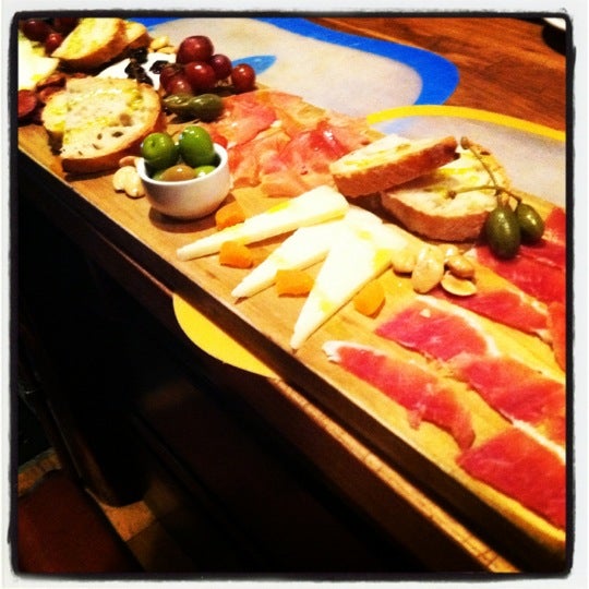 Photo taken at Salumi Tapas and Wine Bar by Victoria L. on 3/25/2012