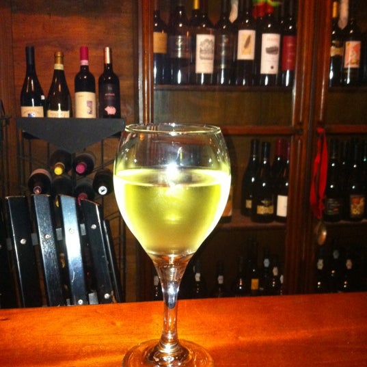 Photo taken at Grand Vin Wine Shop &amp; Bar by Dannielle S. on 4/27/2012