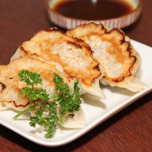 These are O-gyoza.  The 'O' is for 'big' pan-fried dumplings filled with ground pork and vegetables.