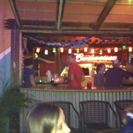 Photo taken at Gilligan&#39;s Island Bar and Grill by Ty R. on 12/28/2011