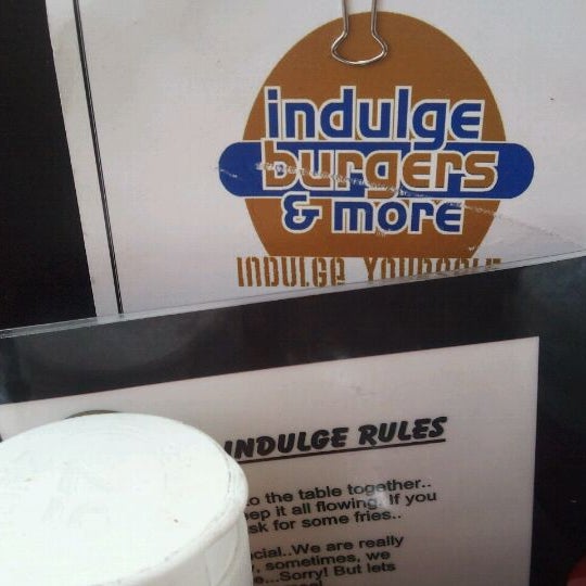Photo taken at Indulge Burgers &amp; More by Lisa B. on 4/7/2012