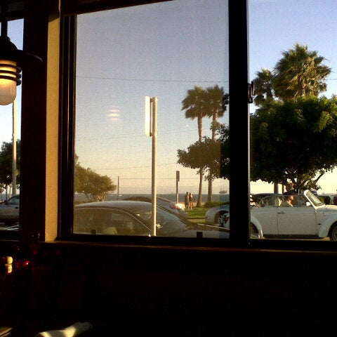 Photo taken at The Hangout Restaurant &amp; Beach Bar by Conrad B. on 7/27/2012