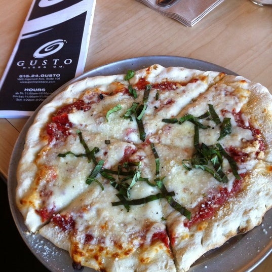 Photo taken at Gusto Pizza Co. by Norah C. on 2/10/2011