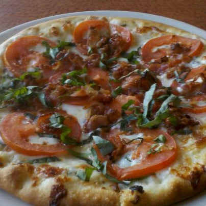 Photo taken at Oggi’s Pizza &amp; Brewhouse Point Loma by Em E. on 1/30/2012