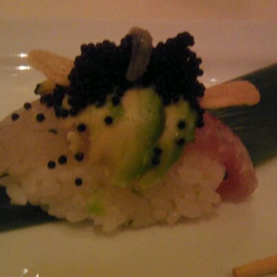 Photo taken at Uptown Sushi by DJ E. on 2/27/2012