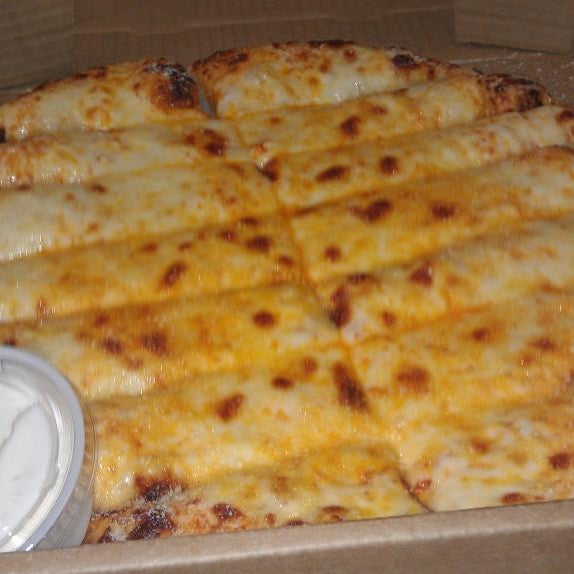 Looking to add a little kick to your meal? Try the Buffalo Cheesy Breadsticks! We slather our homemade dough in Frank's Redhot, mozzarella, and garlic to make this delicious treat!