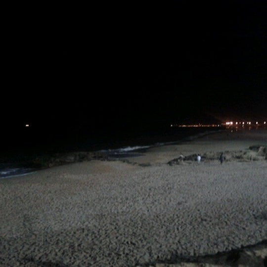 Photo taken at Praia dos Gémeos by Claudia D. on 6/29/2012