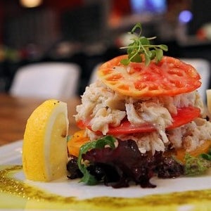 Try the Napoleon layered crab, lightly dressed with a cilantro-lime sauce and showcasing three different heirloom tomatoes. Vivid presentation; memorable flavors. (Joe Bonwich)