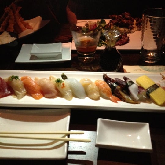 Photo taken at Okura Robata Sushi Bar and Grill by Sydney R. on 1/27/2012
