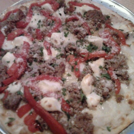 Photo taken at Gusto Pizza Co. by Tina T. on 10/19/2011