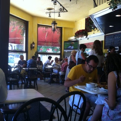 Photo taken at Elysee Café &amp; Bakery by Hollis G. on 7/21/2012