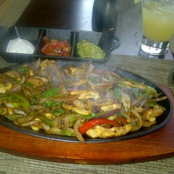 Try their beef & chicken fajitas. One of the best I had in AD. Not good cocktails tho.