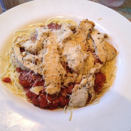 Angel Hair pasta with marinara sauce, topped with chicken.