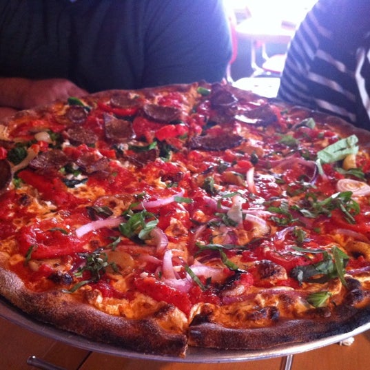 Photo taken at Tucci&#39;s Fire N Coal Pizza by Christopher H. on 3/4/2012