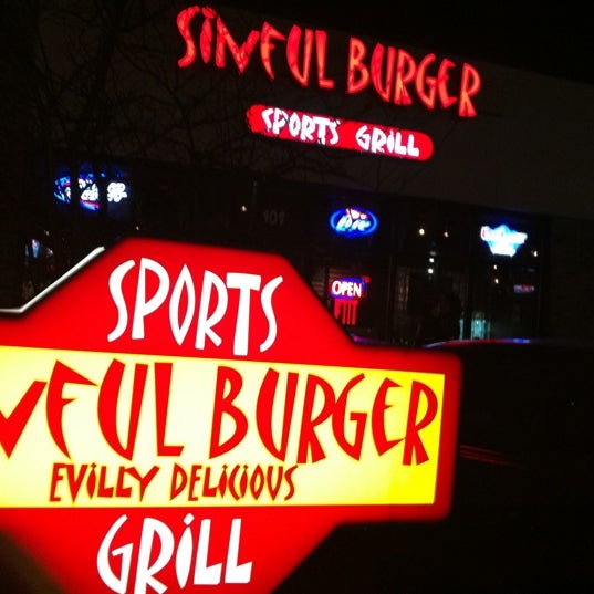 Photo taken at Sinful Burger Sports Grill by Eric W. on 1/8/2012