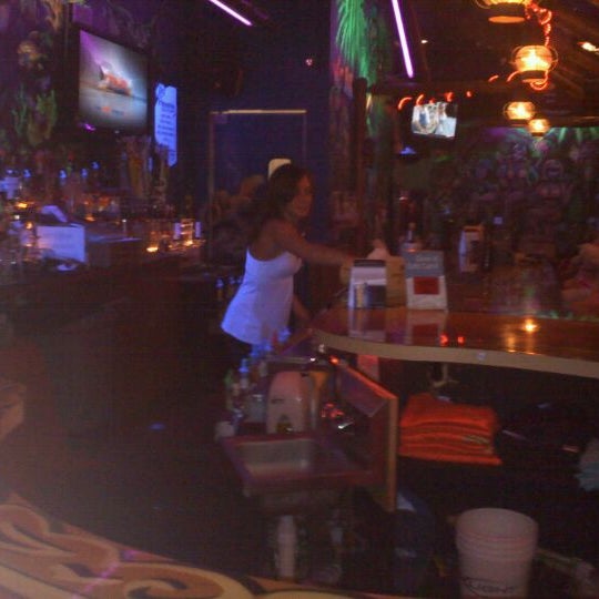 Photo taken at Gilligan&#39;s Tropical Bar &amp; Grill by Nathan F. on 3/18/2012