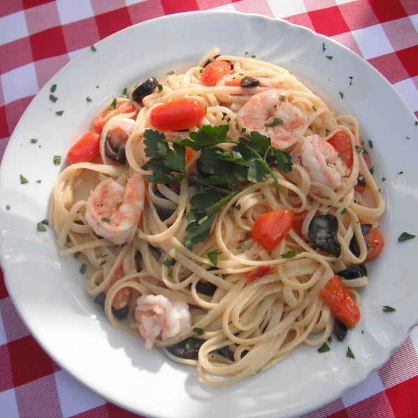 Mediterranean Shrimp Shrimp sauteed with cherry tomatoes, black olives, and linguini pasta in a garlic butter sauce.