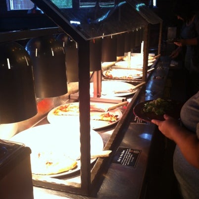 Photo taken at The Rock Wood Fired Pizza by Dean C. on 7/30/2012