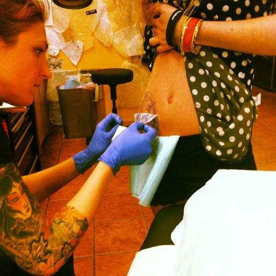Photo taken at Rising Dragon Tattoos by Lynnette P. on 4/18/2012