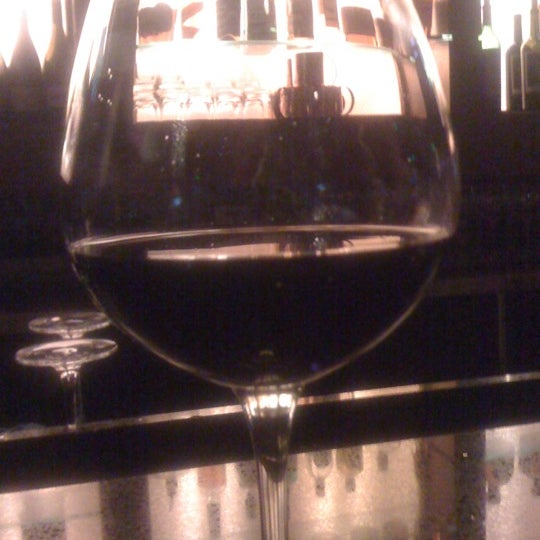 Photo taken at Indulge Bistro &amp; Wine Bar by Christina S. on 7/15/2012