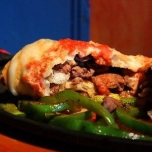 Try the Brinco's Changa, an oversize tortilla stuffed with meat and then deep-fried and topped with gooey, white cheese and a red sauce. Served with a generous supply of beans and rice. (Joe Bonwich)